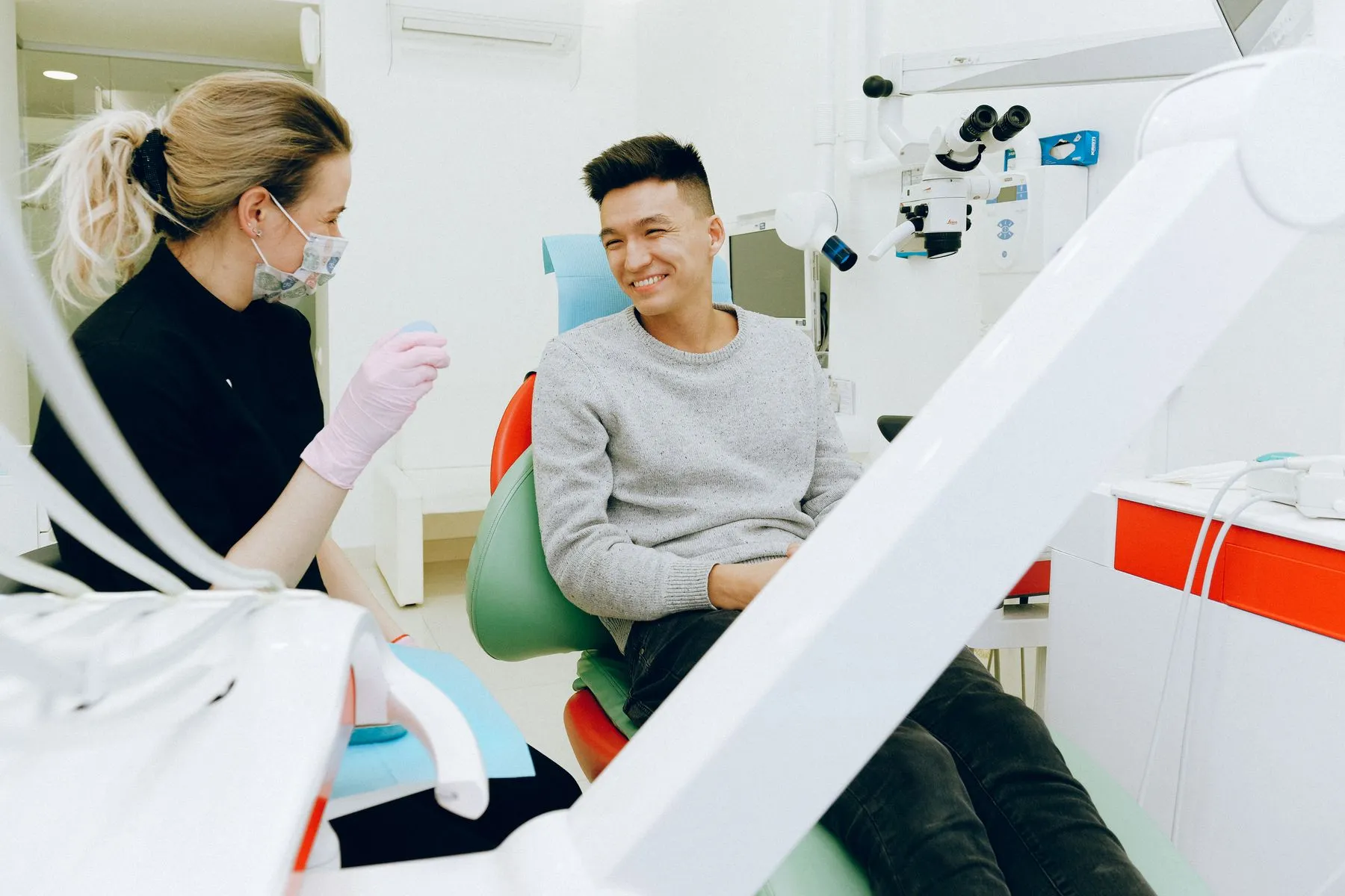 A smiling patient chatting with his dentist